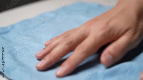 Wallpaper Mural Hand gently touching blue cloth showing detail of fabric Torontodigital.ca