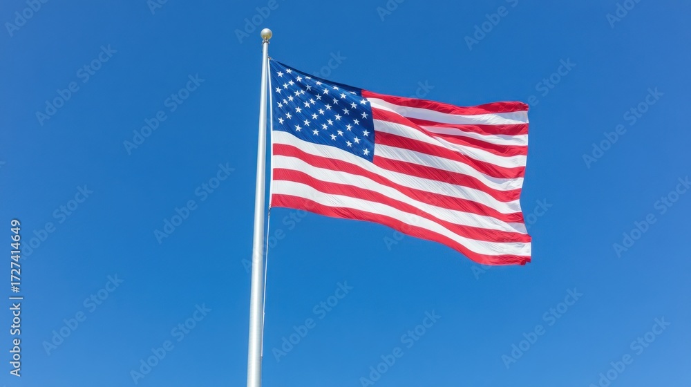 Fototapeta premium Waving american flag clear blue sky patriotic symbol