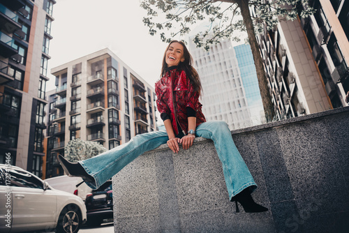 Stylish young woman enjoying an urban outdoor setting in fashionable attire, embracing vibrant city life with a stunning look