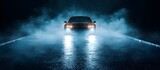 Electric car dark foggy road headlights glowing front view wet asphalt night blue light