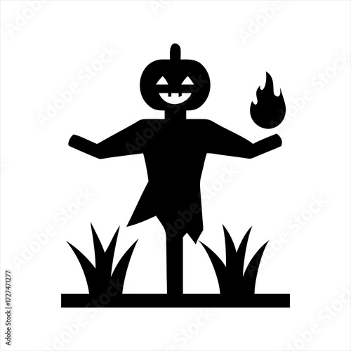 Scary black silhouette of a pumpkin headed scarecrow holding a flame