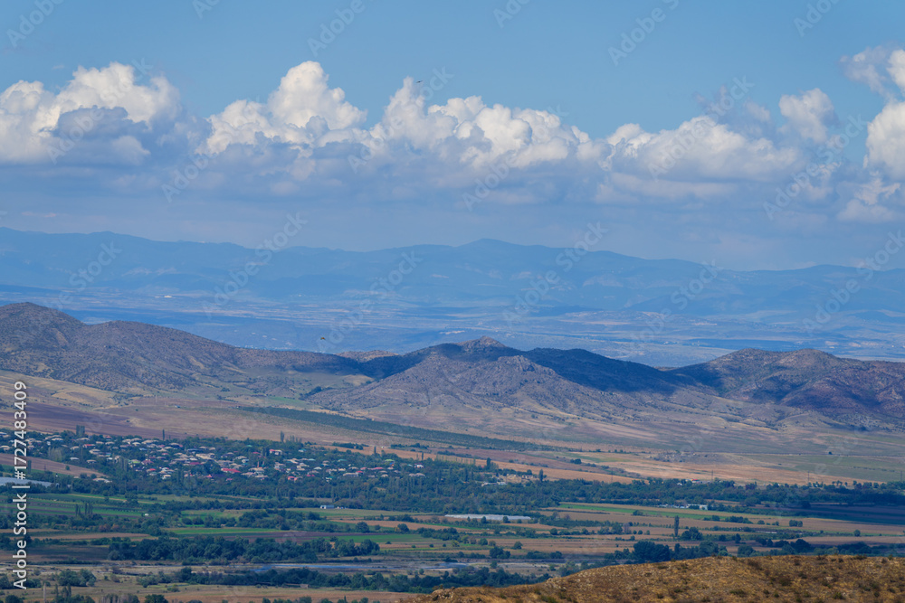 Fototapeta premium Amazing landmark with settlements and mountains and cloudy sky at Armenia-Georgia state border