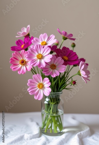 Wallpaper Mural A delicate vase filled with vibrant cosmos flowers in various shades of pink, purple, and white, set against a soft, neutral background, floral, garden, soft Torontodigital.ca