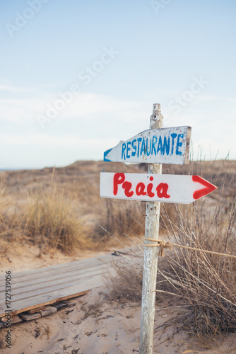 two wooden, makeshift signs at dunes, Costa de Caparica, Portugal