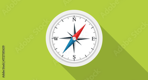 A classic compass with red and blue needles points the way, casting a long shadow on a vibrant green background, symbolizing guidance and exploration