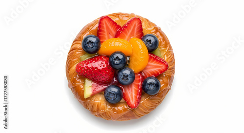 Fruit Danish pastry with fresh berries and mandarin in bright studio lighting on white background for breakfast advertising.