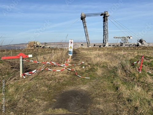 RWE's lignite excavator in the Hambach open-pit mine in front of a barrier tape with No Trespassing signs near the village of Bürgewald (formerly Morschenich), Germany, Europe, on February 25, 2025