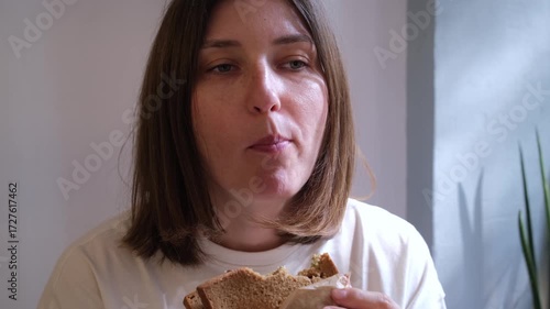 Caucasian Woman Eating Sandwich at Cafe Business Lunch