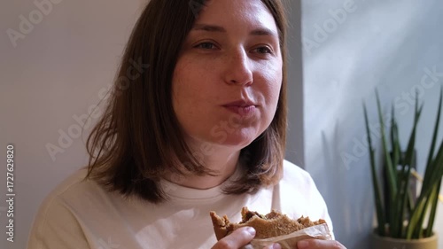 Caucasian Woman Eating Sandwich at Cafe Business Lunch