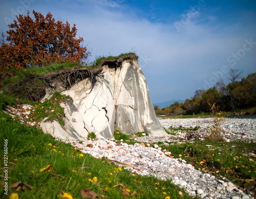 Eroded riverbank with autumnal foliage