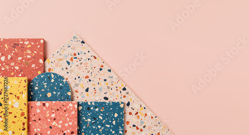 Abstract composition of terrazzo pieces arranged in geometric shapes on a pastel background, modern artistic concept