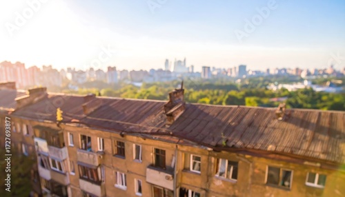 Blurred view of an aging apartment building in a cityscape during sunny golden hour