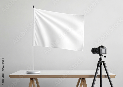 Blank white  flag mockup  on a table with camera isolated on a white background