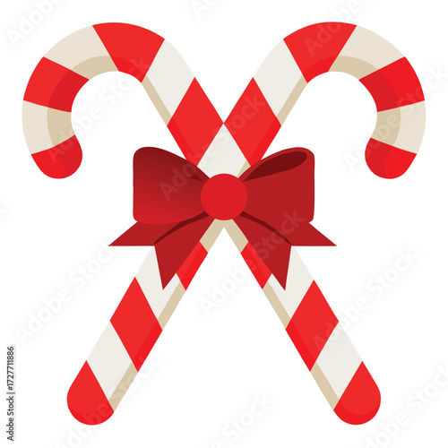 Two crossed candy canes tied with a red bow isolated on white background