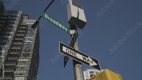 Handheld shot of a Broadway street sign