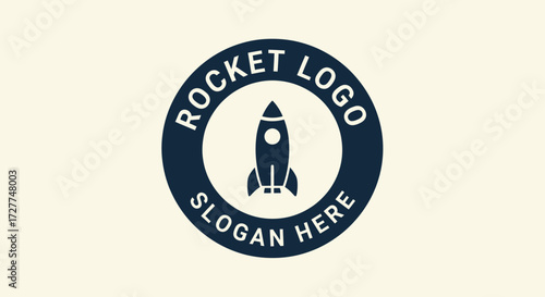 A circular logo featuring a stylized rocket ship icon in the center, surrounded by text "ROCKET LOGO" and "SLOGAN HERE" in a dark blue ring.