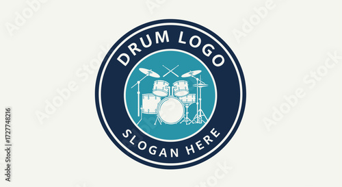 Circular logo design featuring a drum set, with text and a simple color scheme.