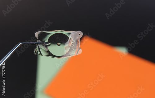 Close-up of a transparent tape dispenser with colorful background