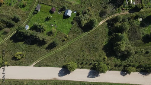 plots of land and private land for individual farming next to the road in summer taken from a drone height