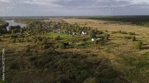 an old, out-of-the-way settlement in a remote area surrounded by forests, wooden houses stand in summer among greenery