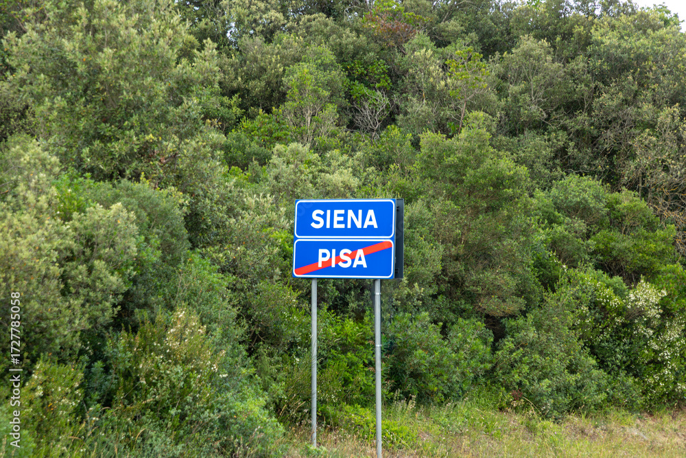 Fototapeta premium welcome street sign to Siena while leaving Pisa at the street for the car driver