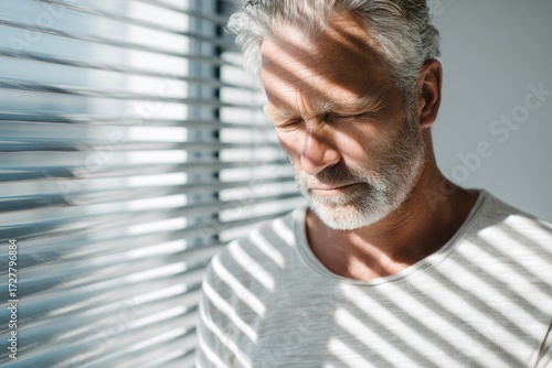 Older man suffering intimate activity decline and male potency issues. Mature man with closed eyes feeling deep sadness and personal life difficulties.