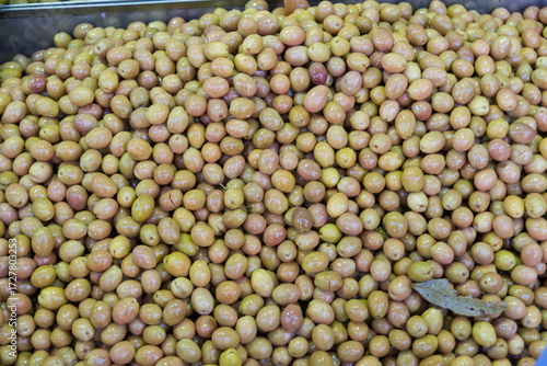 Green pickled olives on sale at a local food market.