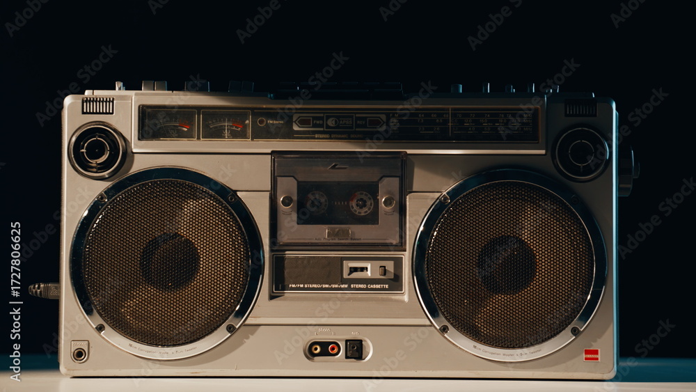 Fototapeta premium Closeup retro boombox standing on table in evening light. Old cassette player 