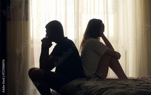 A couple sits together in silence, emotionally distant and disconnected. Despite physical closeness, tension and isolation dominate. A visual concept of relationship crisis and mental health.