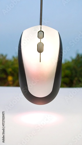 Computer mouse suspended in the air