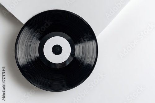 Minimalist Black Vinyl Record with White Label on Clean White Surface, Retro Music Concept.