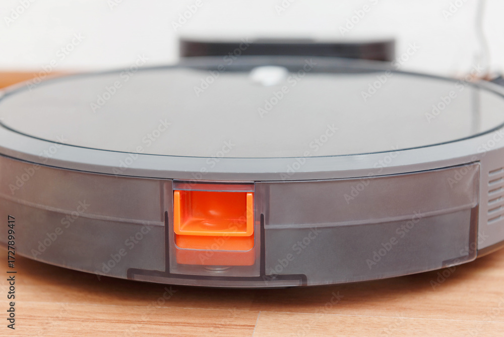 Fototapeta premium Robot vacuum cleaner go to charging dock after it is finished. Robotic Vacuum