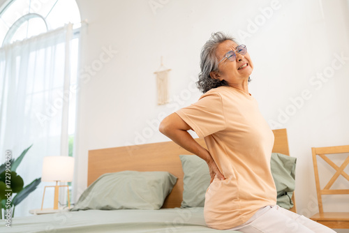 Bild auf Leinwand Asian senior woman suffering from backache by the reason of degenerative disc disease, muscle inflammation or arthritis symptoms