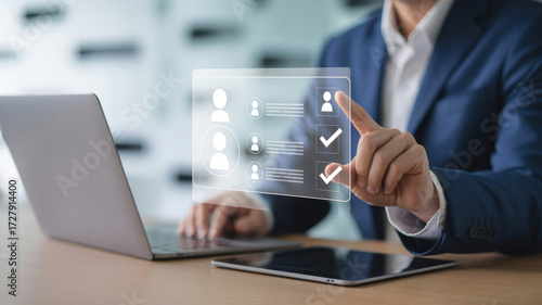 Wallpaper Mural A businessman using a laptop to search for an employee or job seeker profile to fill a vacancy, hr and recruitment concept Torontodigital.ca