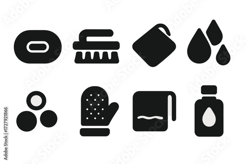 Hygiene Icons Collection. Solid, filled icon set of scrubbing hygiene: soap bar, scrub brush, washcloth, water drops, bubbles, exfoliating glove, towel, shower