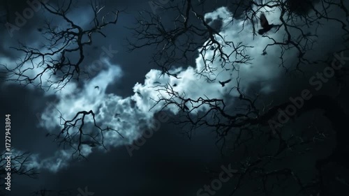 Ominous Flock of Ravens Flying Across a Spooky Moonlit Night Sky Through Bare Trees.