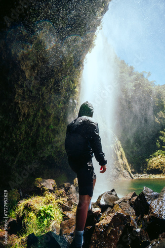 hiker in the mountains at a waterfall