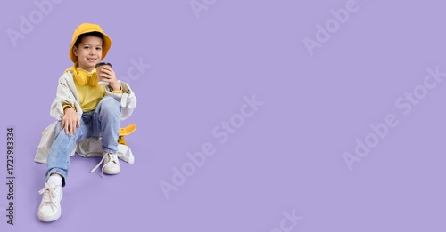 Little Asian boy with tea s...