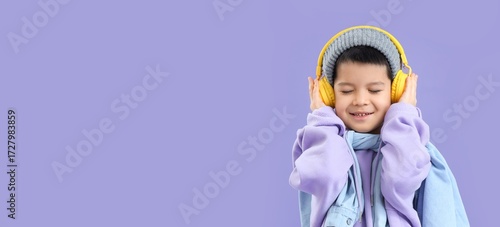 Little Asian boy in headpho...