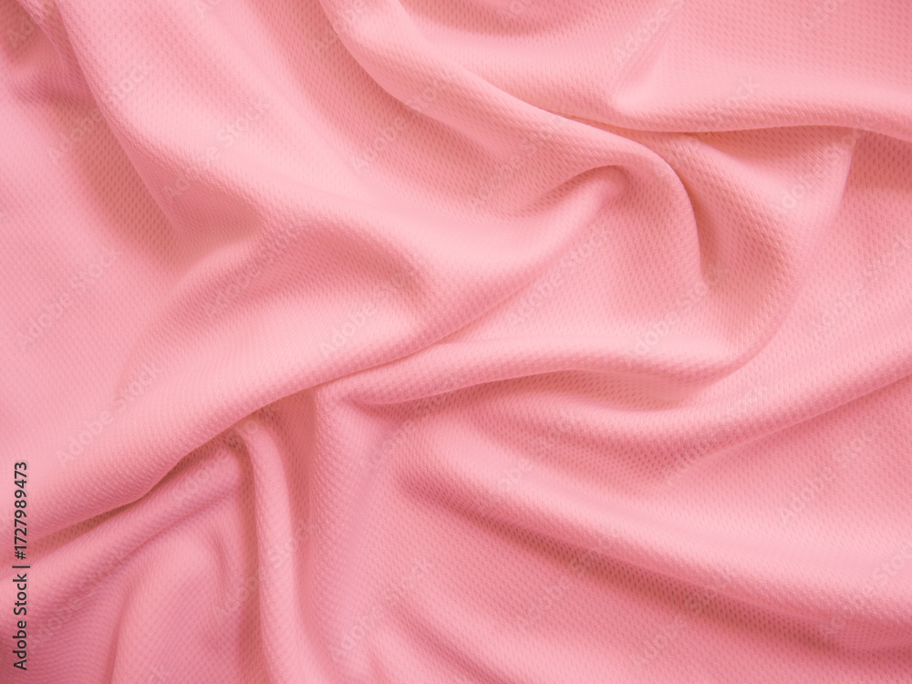 Obraz premium Pink crumpled fabric background. Wavy cloth texture