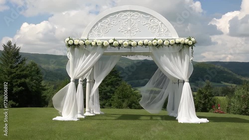 Decorative Arched Structure Made of Wood and Fabric Erected on Grassy Field for Nuptial Ceremony with Mountainous Terrain
