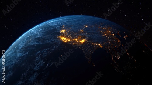 View of Earth from space showing the night side with illuminated city lights across South Asia and surrounding regions under a starry sky
