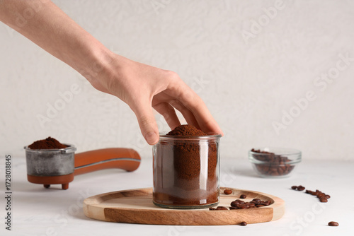 Hand holding glass jar of f...