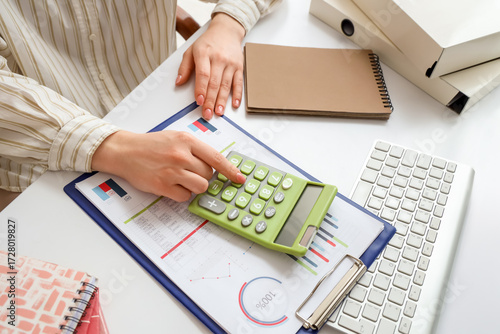 Female accountant with calc...