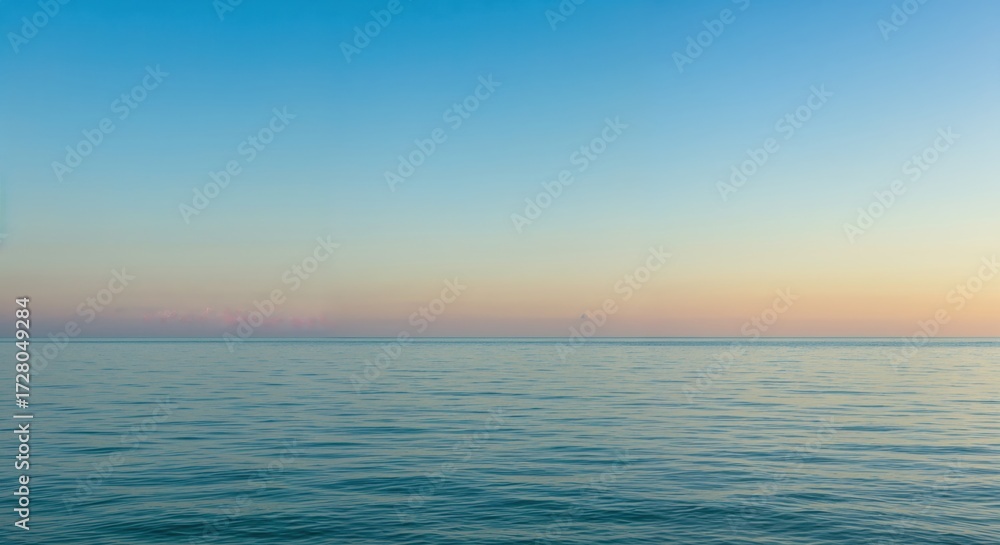 Fototapeta premium Serene Horizon: A calm sea stretches out beneath a gradient sky. The scene evokes a sense of peace and tranquility.