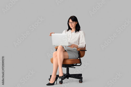 Young secretary with laptop...