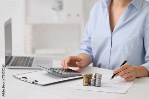 Businesswoman with coins us...