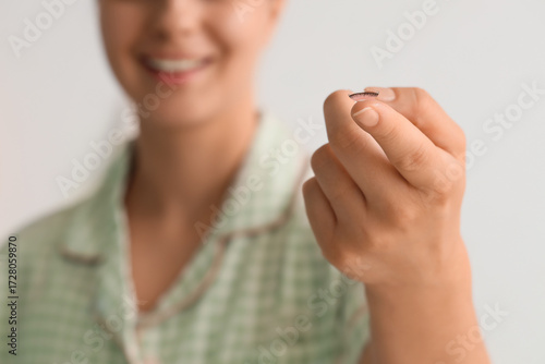 Young woman holding contact...