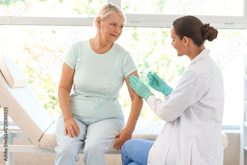 Female doctor vaccinating s...
