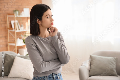 Thoughtful young woman at home